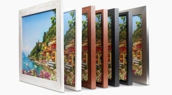 Assorted framed canvas prints showing different frame styles and sizes on a wall